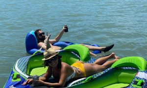 Couple floating on water loungers on the lake