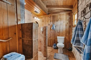 large bathroom with wooden walls, tile floor, and walk-right-in shower