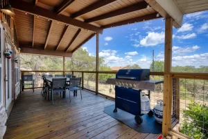 Wooden cover deck with grill, and a table
